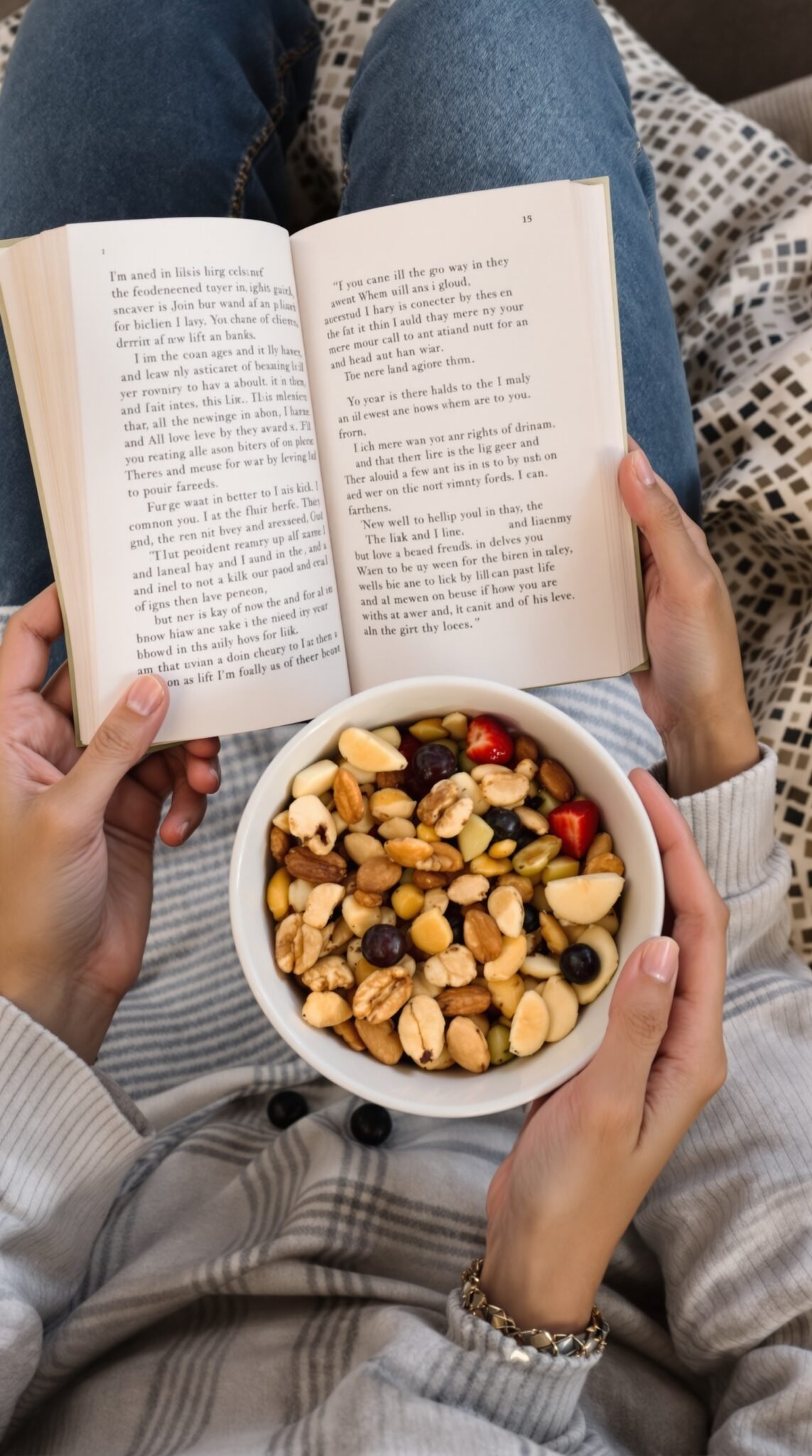 A person reading a book while holding a bowl of mixed nuts and fruits, illustrating the concept of mindful snacking.