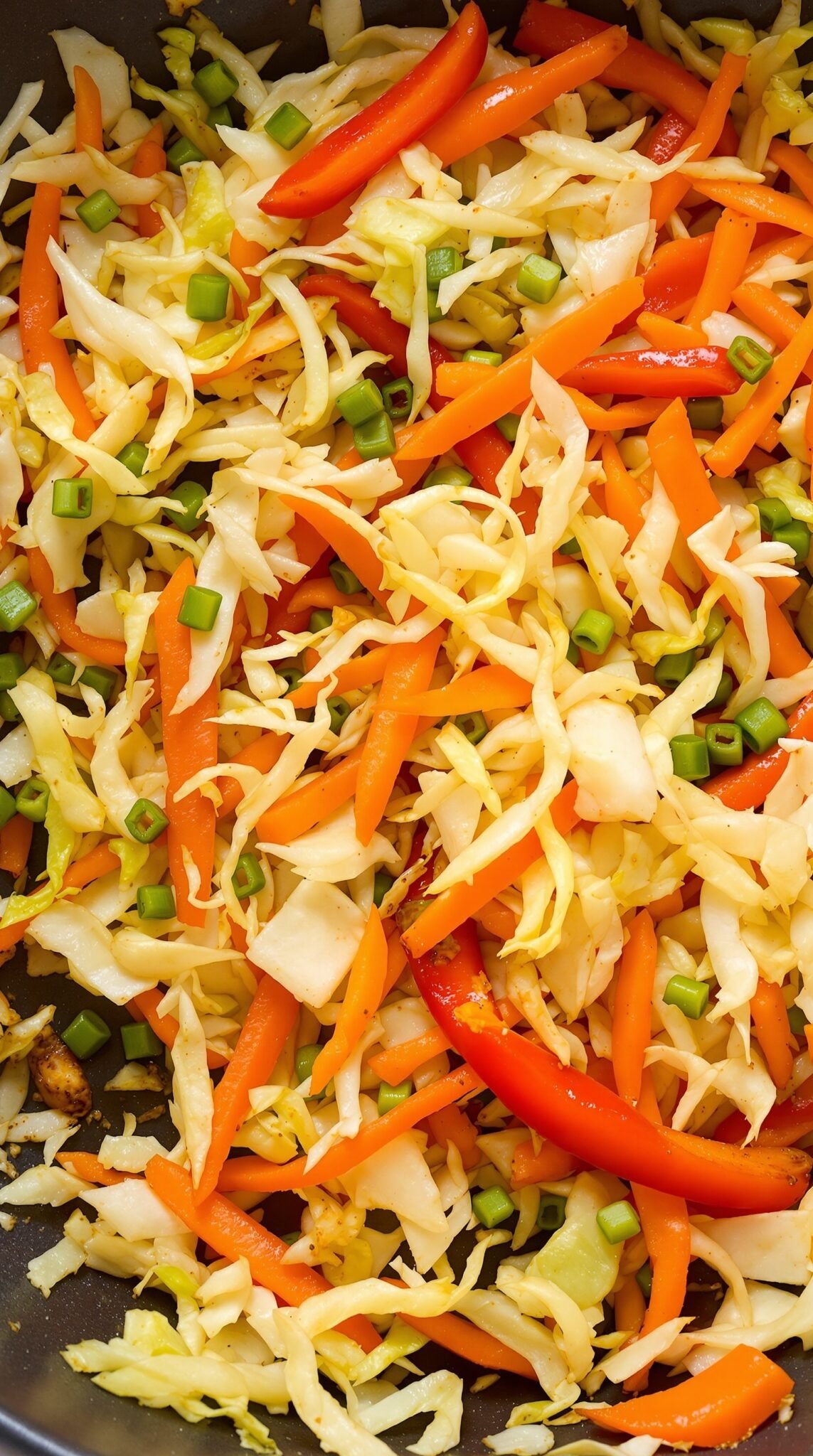 Colorful cabbage stir-fry with red and yellow bell peppers and green onions