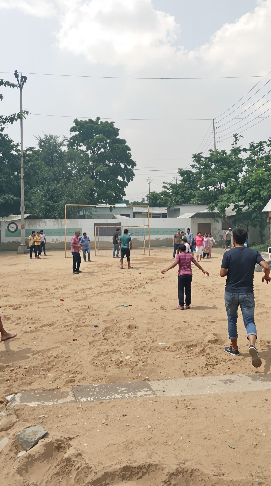 A group of people participating in a community sports game on a sandy court.